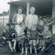 Roberts Home, children in metal rocker with house mothers